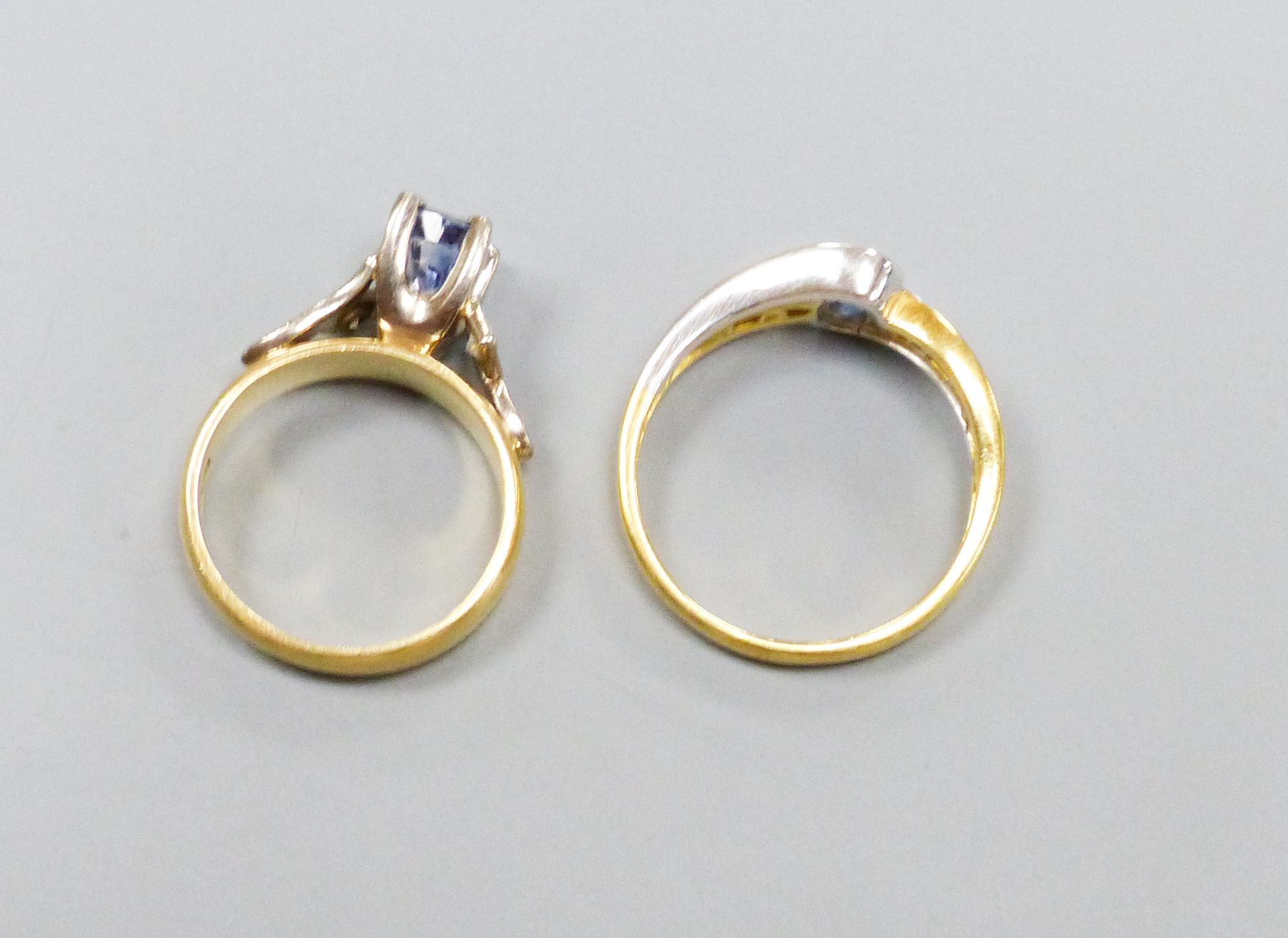 Two modern 18ct gold, sapphire and diamond set dress rings including three stone sizes I & P, gross weight 10 grams.